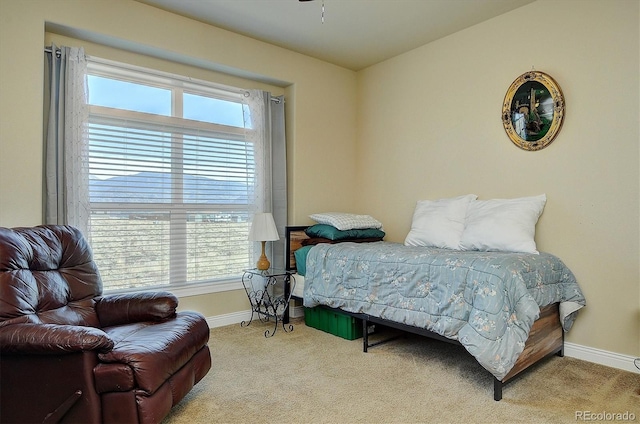carpeted bedroom with baseboards and multiple windows