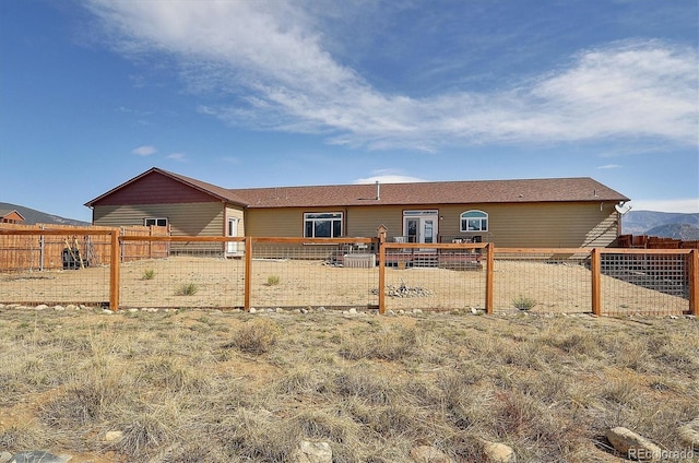 rear view of house with a fenced backyard
