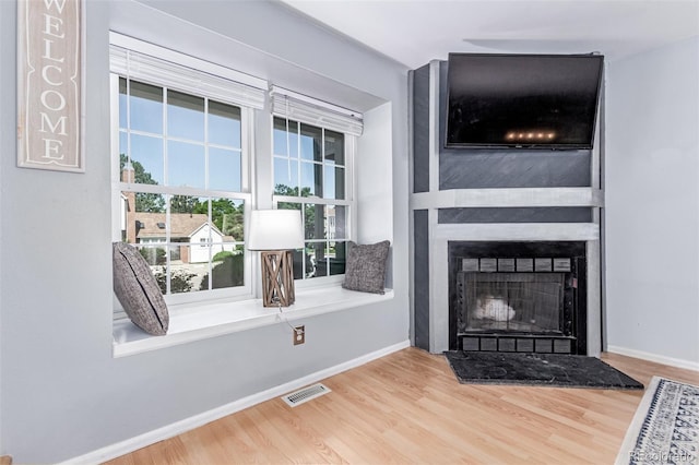4676 S Dillon Ct Unit G, Aurora, CO 80015 - unfurnished living room with wood finished floors and a large fireplace