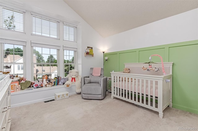 4676 S Dillon Ct Unit G, Aurora, CO 80015 - bedroom featuring carpet flooring, a nursery area, high vaulted ceiling, and a decorative wall