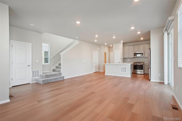 unfurnished living room with light hardwood / wood-style flooring