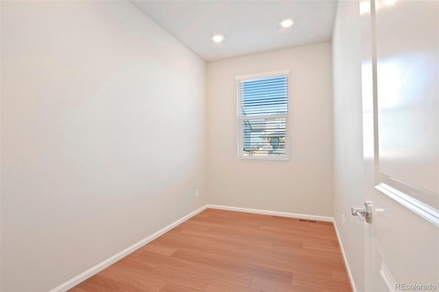 unfurnished room with light hardwood / wood-style floors