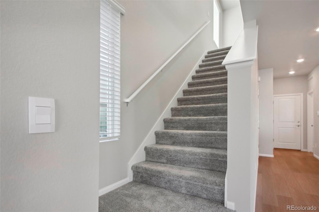 stairs featuring hardwood / wood-style flooring