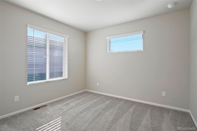 unfurnished room featuring light colored carpet