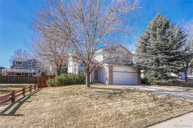 view of front of property with a garage and a front lawn