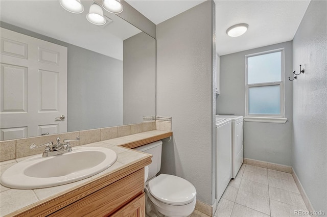 bathroom featuring vanity, tile patterned floors, washer and clothes dryer, and toilet