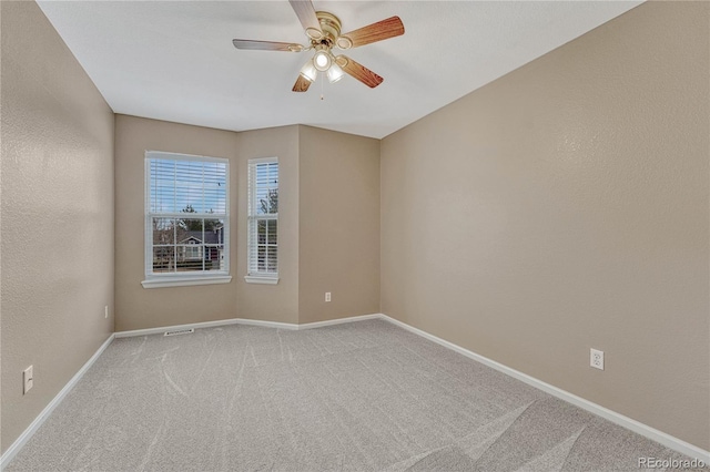 carpeted empty room with ceiling fan