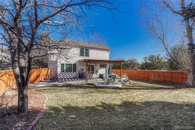 rear view of property featuring a pergola, a patio, and a lawn