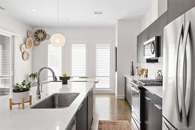 4395 Zuni St, Denver, CO 80211 - kitchen featuring stainless steel appliances, a sink, light countertops, modern cabinets, and recessed lighting
