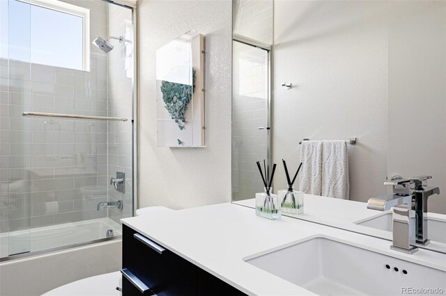 4395 Zuni St, Denver, CO 80211 - bathroom with vanity, combined bath / shower with glass door, and toilet