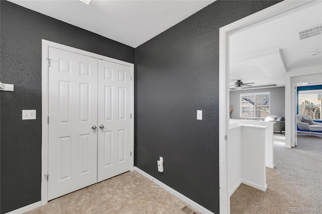 bedroom featuring light carpet and a closet