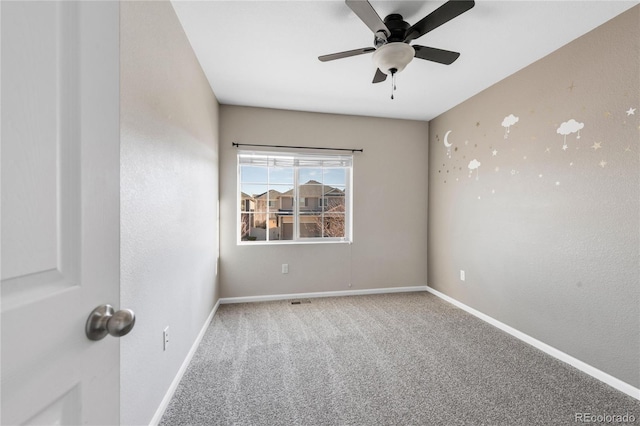 spare room with carpet flooring and ceiling fan