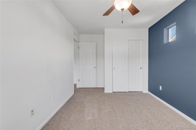 unfurnished bedroom with a closet, ceiling fan, and light colored carpet