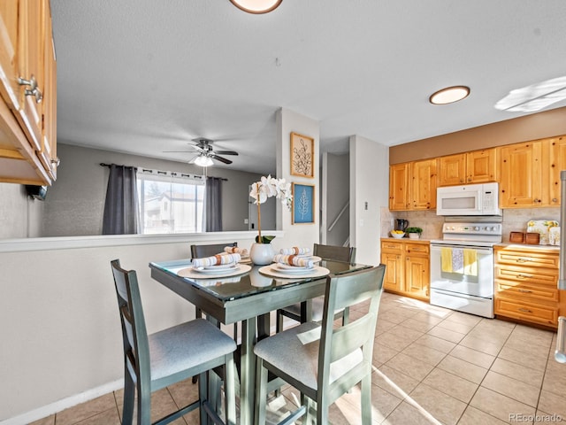 kitchen featuring decorative backsplash, light tile patterned floors, ceiling fan, light brown cabinets, and white appliances