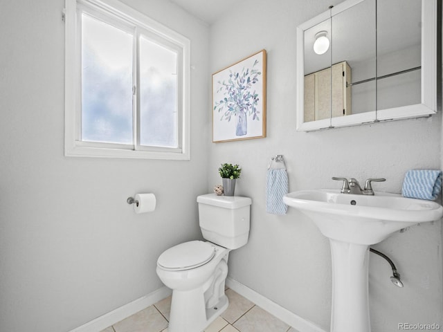 bathroom featuring sink, tile patterned floors, and toilet