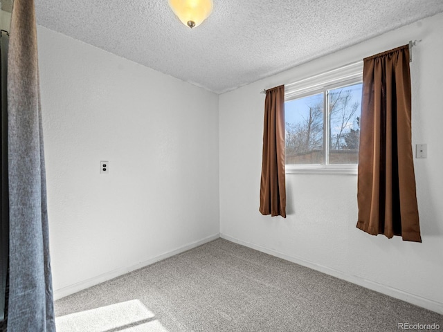 empty room featuring carpet and a textured ceiling