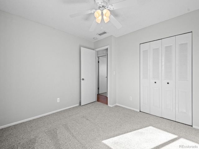 unfurnished bedroom featuring a closet, ceiling fan, and carpet flooring