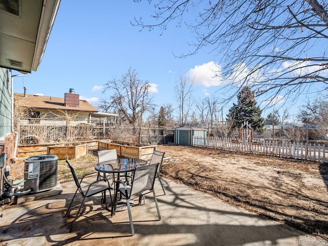 view of patio / terrace with a shed and central AC