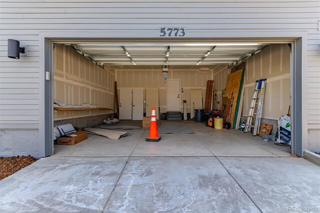 garage featuring a garage door opener and concrete driveway