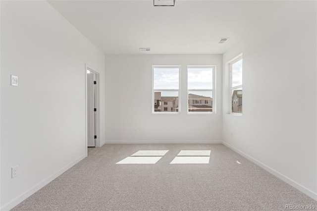 unfurnished room featuring light carpet, healthy amount of natural light, and baseboards