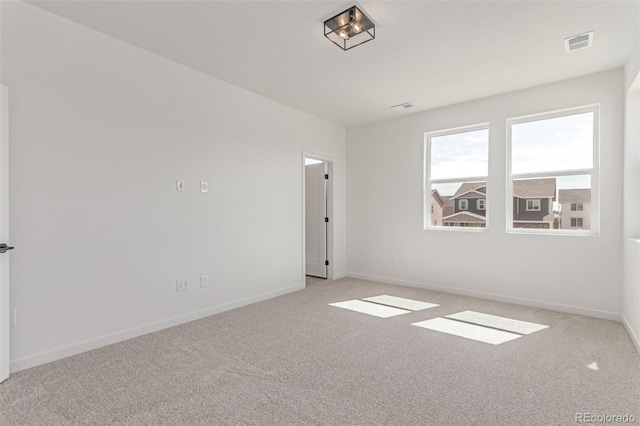 unfurnished room with carpet flooring and baseboards