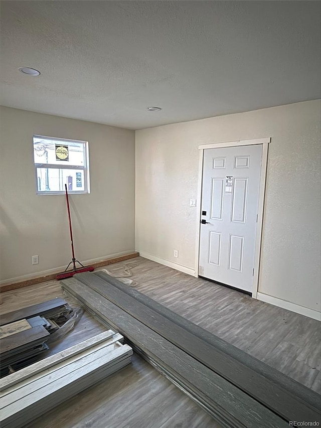 interior space with wood-type flooring and a textured ceiling