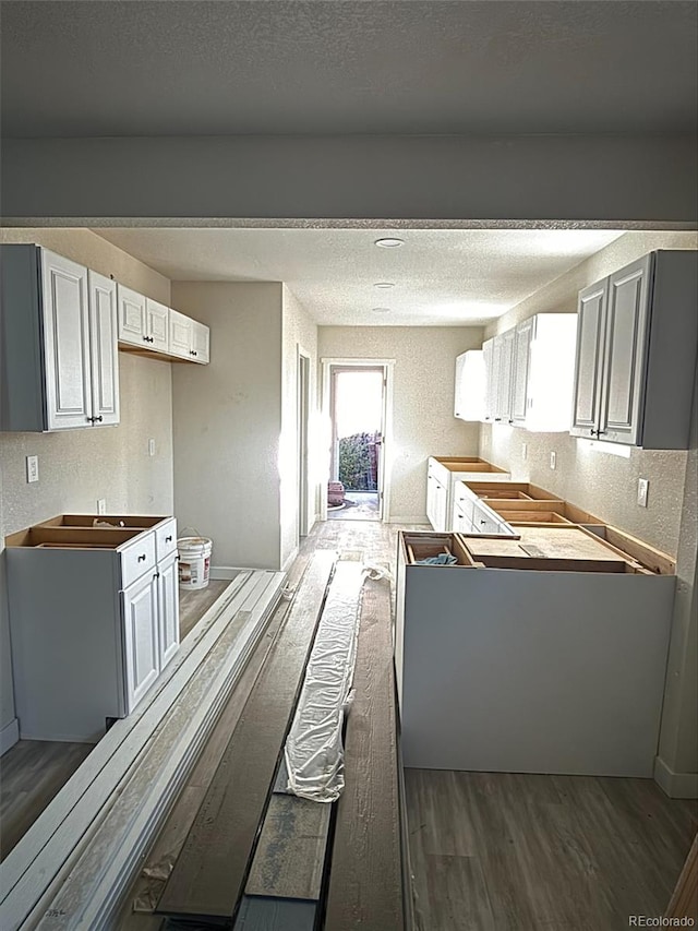 kitchen with dark wood-type flooring and a textured ceiling