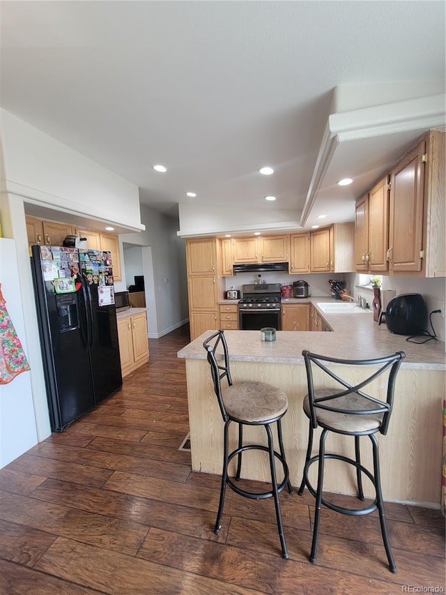 58117 E 42nd Dr, Strasburg, CO 80136 - kitchen with black fridge with ice dispenser, stainless steel range with gas cooktop, dark wood-style floors, a peninsula, and recessed lighting