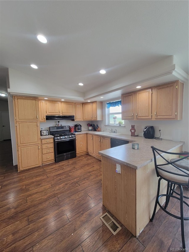 58117 E 42nd Dr, Strasburg, CO 80136 - kitchen with stainless steel range with gas cooktop, dark wood-style flooring, a peninsula, light brown cabinetry, and ventilation hood