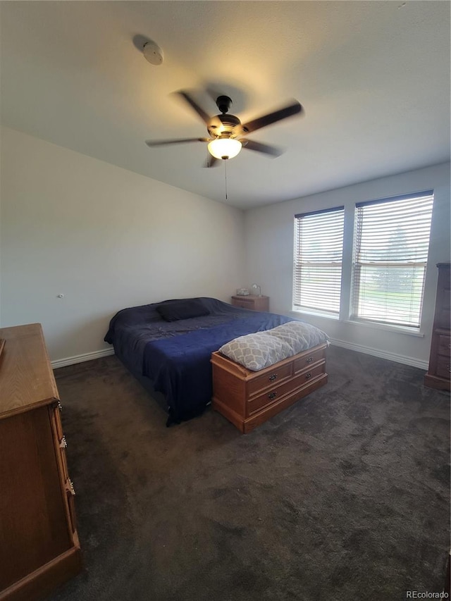 58117 E 42nd Dr, Strasburg, CO 80136 - bedroom with baseboards, dark colored carpet, and a ceiling fan