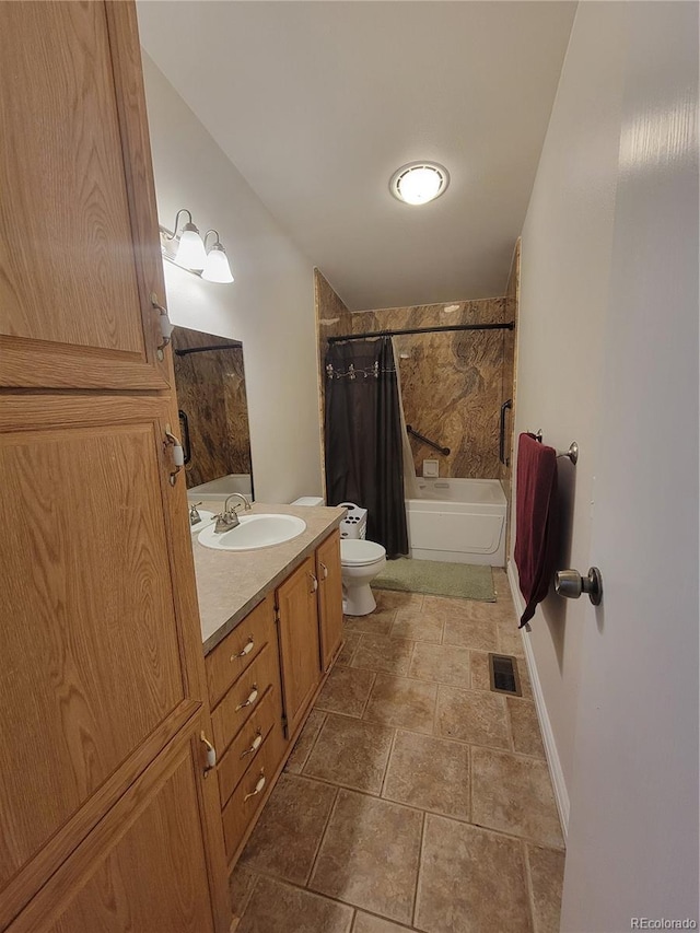 58117 E 42nd Dr, Strasburg, CO 80136 - full bath featuring shower / bath combo, vanity, toilet, baseboards, and stone finish floors