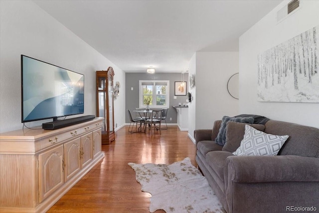 1568 S Osceola Way, Denver, CO 80219 - living area with light wood-style floors and baseboards