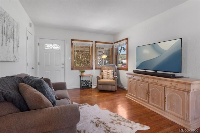 1568 S Osceola Way, Denver, CO 80219 - living area with dark wood-style floors and baseboards