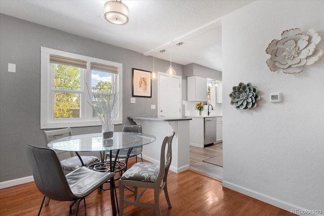 1568 S Osceola Way, Denver, CO 80219 - dining space with baseboards and light wood-style flooring