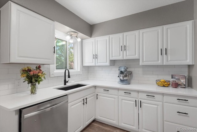 1568 S Osceola Way, Denver, CO 80219 - kitchen featuring stainless steel dishwasher, a sink, white cabinets, and tasteful backsplash