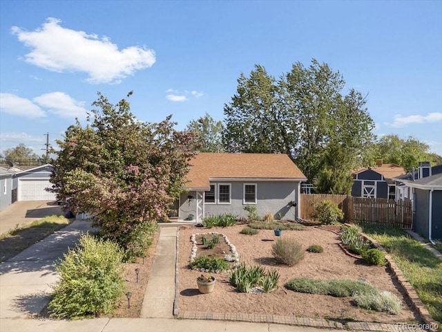 1568 S Osceola Way, Denver, CO 80219 - view of front facade with concrete driveway, stucco siding, and a detached garage