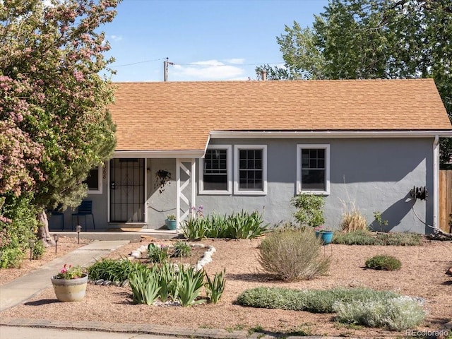 1568 S Osceola Way, Denver, CO 80219 - view of front of property featuring stucco siding, a shingled roof, and covered porch