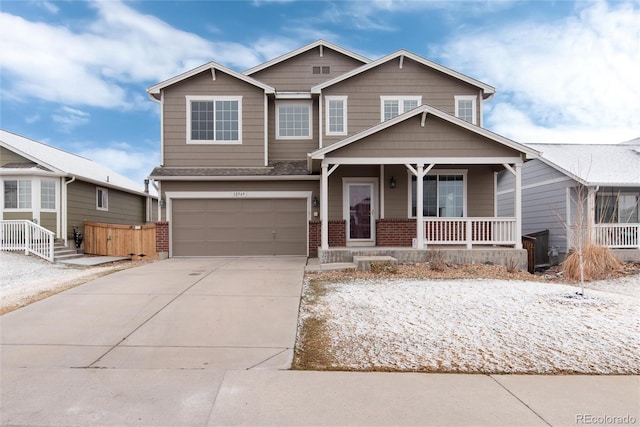 craftsman house with a porch, concrete driveway, brick siding, and a garage