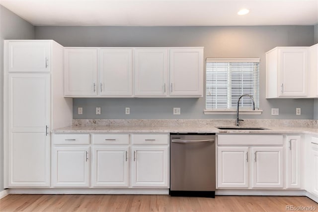 kitchen featuring a sink, light wood finished floors, white cabinetry, and stainless steel dishwasher