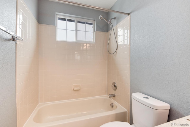 full bath featuring a textured wall, bathing tub / shower combination, and toilet