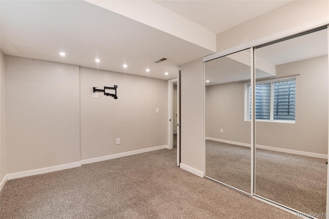 finished below grade area with carpet floors, recessed lighting, visible vents, and baseboards