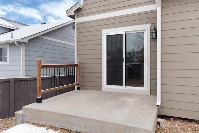 property entrance with a patio area and fence