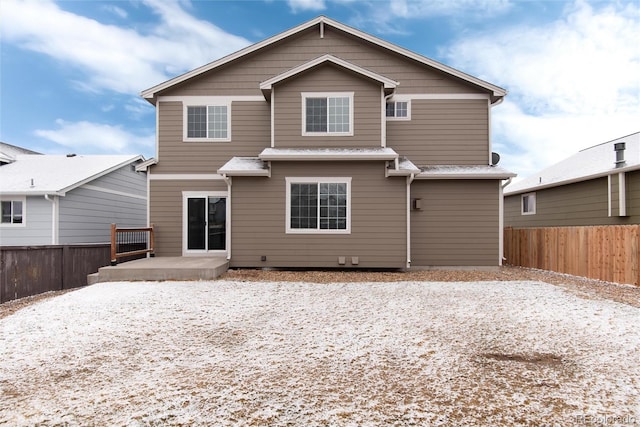 rear view of house featuring a patio and fence