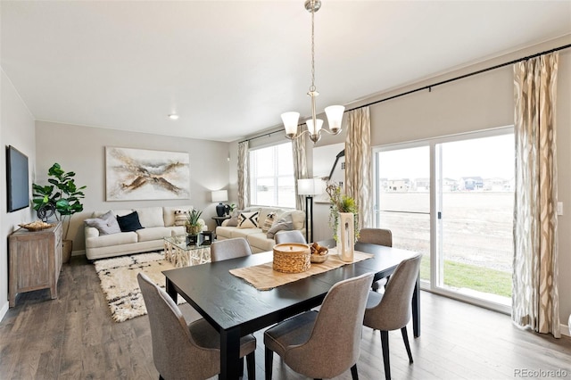 dining room with hardwood / wood-style flooring and an inviting chandelier