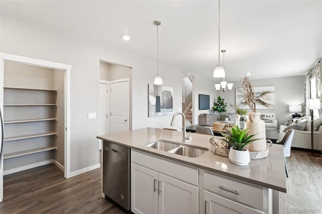 kitchen with dark wood-type flooring, a kitchen island with sink, stainless steel dishwasher, and sink