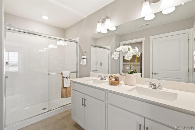 bathroom with vanity and a shower with shower door