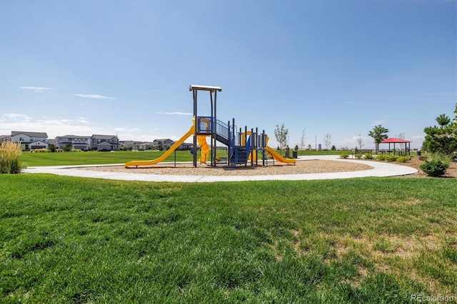 view of jungle gym featuring a lawn