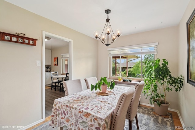 2792 S Stuart St, Denver, CO 80236 - dining area with dark wood-style flooring, a chandelier, and baseboards