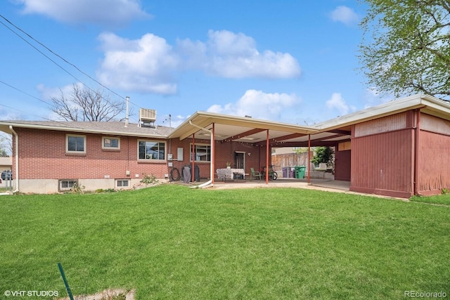 2792 S Stuart St, Denver, CO 80236 - rear view of house with a yard, a patio, and brick siding