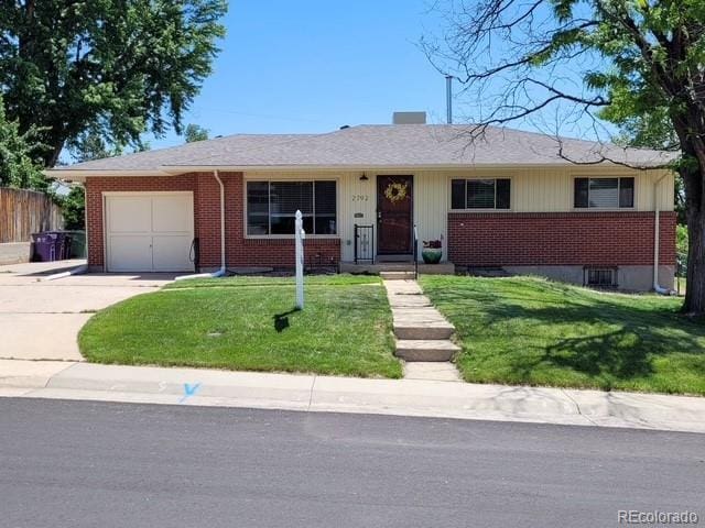 2792 S Stuart St, Denver, CO 80236 - view of front of house with brick siding, an attached garage, and driveway